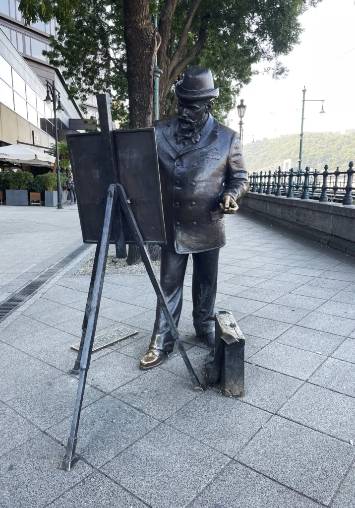 Statue of Ignác Roskovics, the Hungarian painter, depicted painting on an easel in Budapest